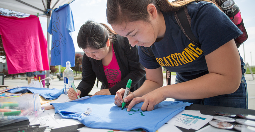 Campus community members create T-shirts for the Sexual Assault Awareness Month Clothesline Project.