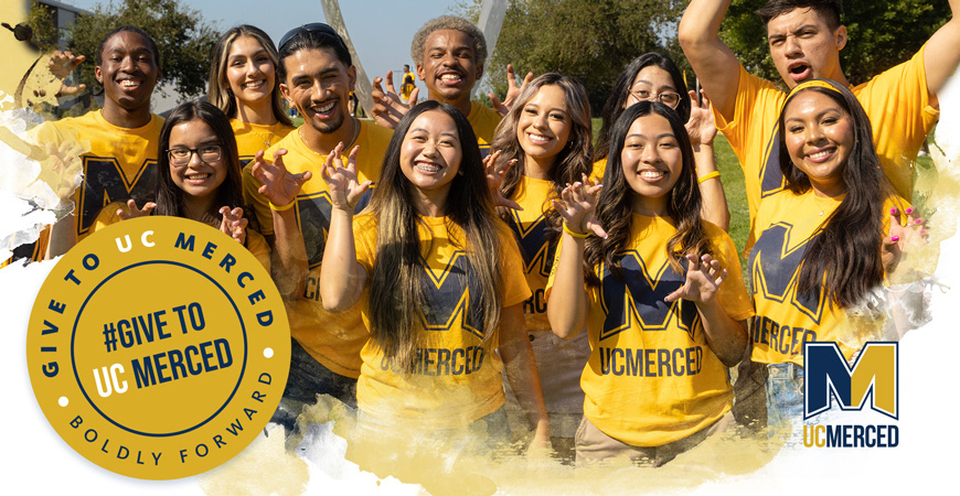 UC Merced students smile while making a Bobcat paw with their hands.